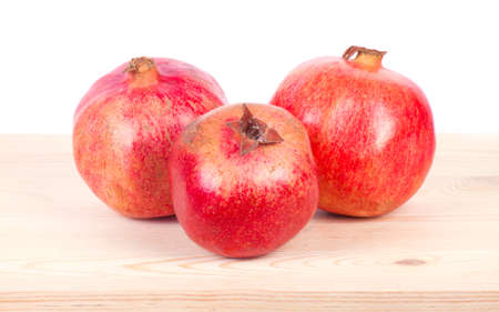 Ripe pomegranate fruit with half isolated on white backgroundの写真素材