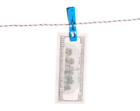 Dollar bills hanging on rope attached with clothes pins. Money-laundering concept.の写真素材