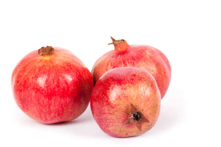 Ripe pomegranate fruit with half isolated on white backgroundの写真素材