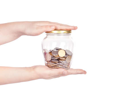 image of female hand putting a coin into glass bottle, saving conceptの写真素材