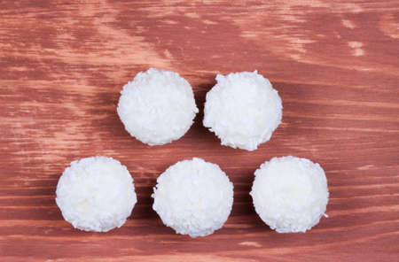 coconut candies on a wooden backgroundの写真素材