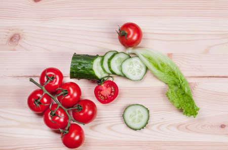 vegetables for salad on a wooden boardの写真素材