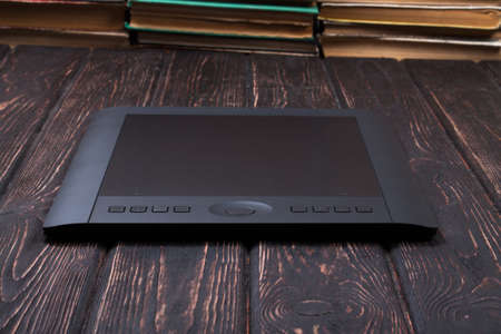 Close up of black graphic tablet over woodの写真素材