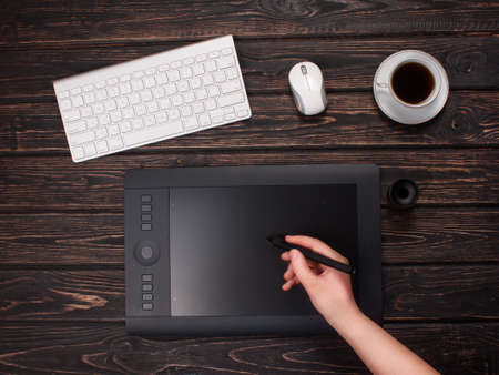 Top view mock-up of graphic designer workplace. Cup coffee, clipboard.の写真素材