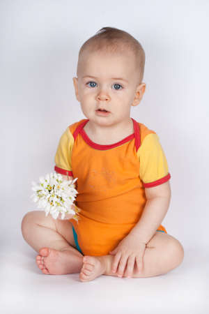spring portrait boy with bouquet of flowers. Child with white snowdrops.の写真素材