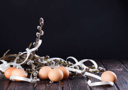 Easter eggs and young willow branchesの写真素材