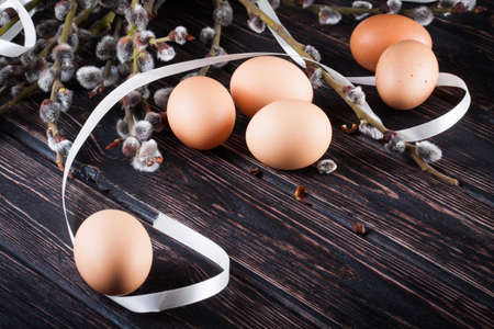 Easter eggs and young willow branchesの写真素材