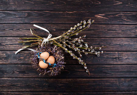 Easter eggs and young willow branchesの写真素材