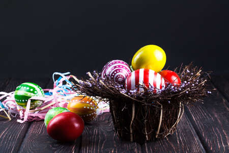 Easter eggs in the basket of wooden boardsの写真素材