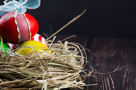Easter eggs in the nest on rustic wooden backgroundの写真素材