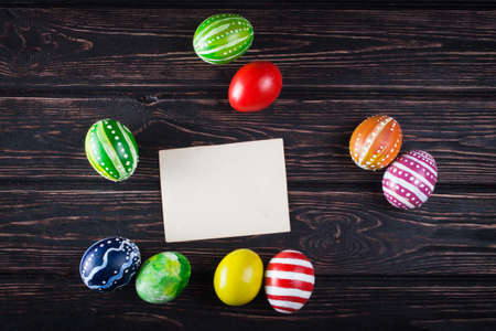Easter eggs with card on rustic wooden backgroundの写真素材