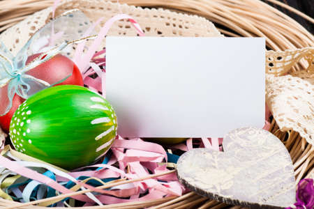 Easter eggs on wooden background with card