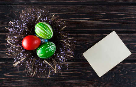 Easter eggs in the basket with card of wooden boards