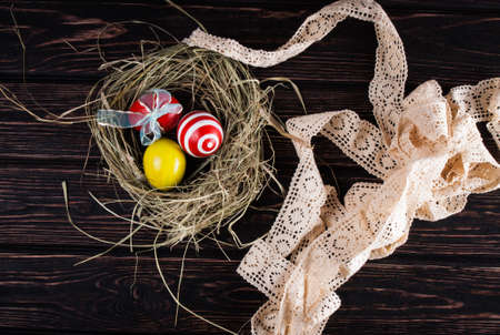 Easter eggs in the nest on rustic wooden backgroundの写真素材