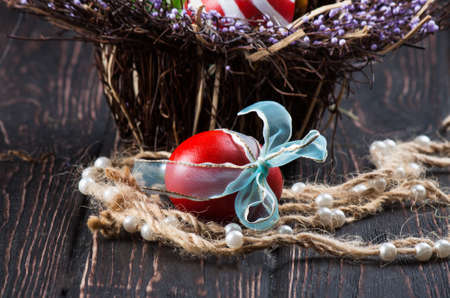 Easter eggs in the basket of wooden boardsの写真素材