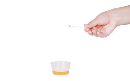 Holding disposable pregnancy test isolated on white background.の写真素材