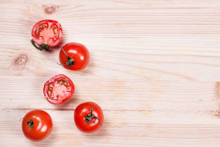Fresh cherry tomatoes on rustic wooden background