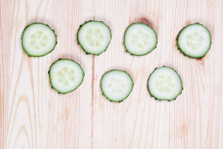 Fresh cucumber slices on wooden backgroundの写真素材
