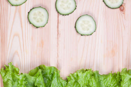 Fresh cucumber slices on wooden backgroundの写真素材