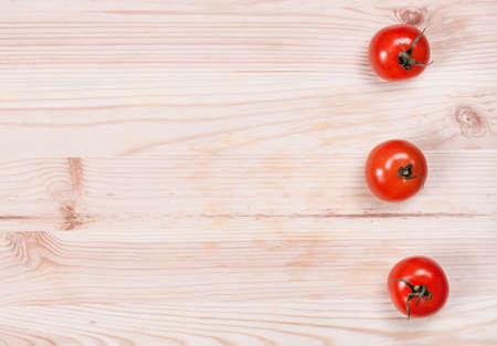 Fresh cherry tomatoes on rustic wooden backgroundの写真素材