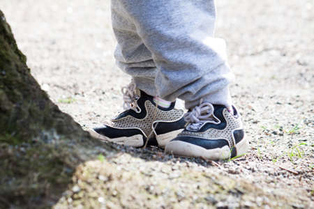 Two pairs of legs, child and mother or father with colorful snickers
