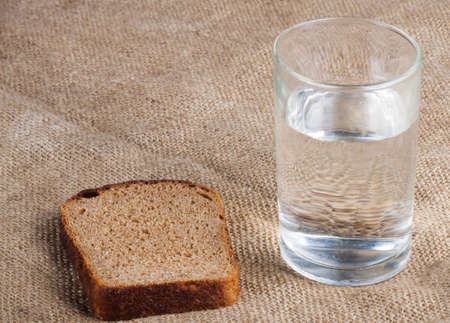 whole grain bread isolated on sack clothの写真素材