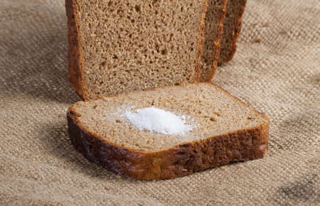 whole grain bread isolated on sack clothの写真素材