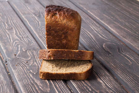 whole grain bread isolated on wood deskの写真素材
