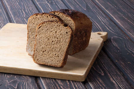 whole grain bread isolated on wood deskの写真素材