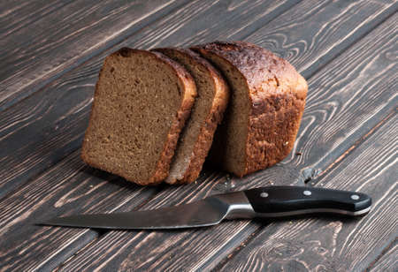 whole grain bread isolated on wood deskの写真素材