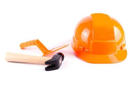 Toy construction helmet and tools over a white background. Children toy toolsの写真素材