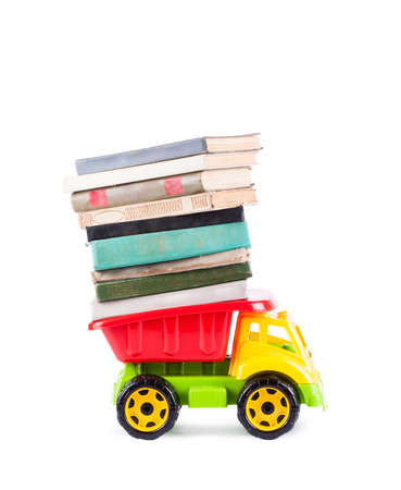 toy truck with a stack of books on the back isolated on white backgroundの写真素材