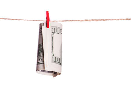 Dollar bills on a red clothespin on rope isolated on white backgroundの写真素材