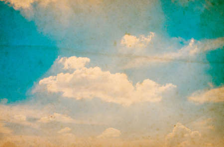 Retro photo with noisy texture. Blue sky with clouds. The sky with clouds for background. Nature backgroundの写真素材