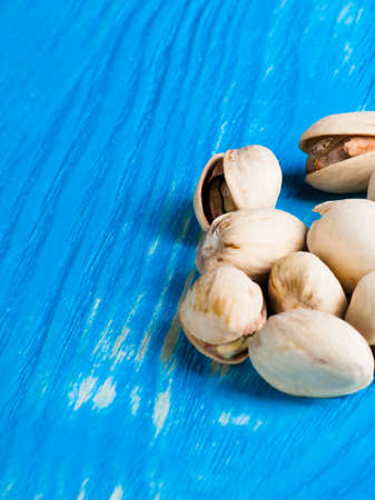 Roasted pistachios on a wood desk.の写真素材