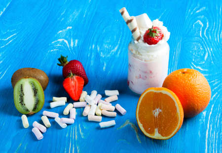 Milkshake with fruit and nuts. Dairy desserts on wood deskの写真素材