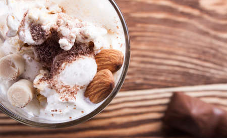 Latte coffee in cup on wood desk.の写真素材