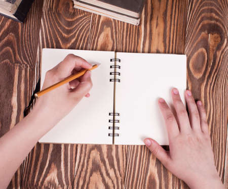 Working student writing on a book. View from aboveの写真素材