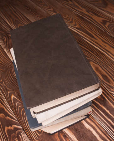 Old books on wood desk.