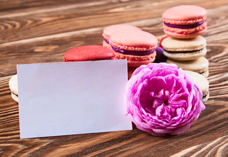 Multicolored macaroon on brown boards with card.の写真素材