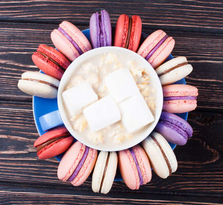 Cup of coffee and macaroons on the boardの写真素材