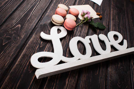Macaroon with an inscription love on the boardsの写真素材