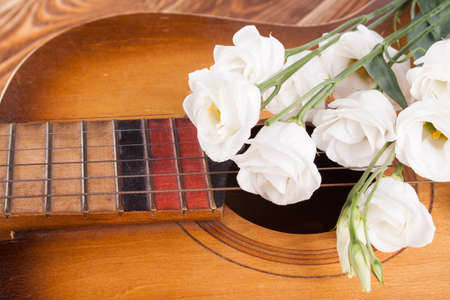 Guitar on wood desk with rose. Musicの写真素材