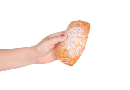 Fresh bun in his hand isolated on white backgroundの写真素材