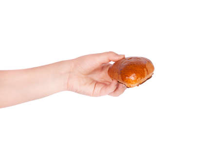 Fresh bun in hand isolated on white background