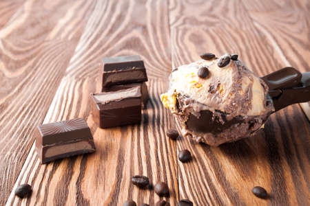 Ice cream with a spoon on a wooden board.の写真素材