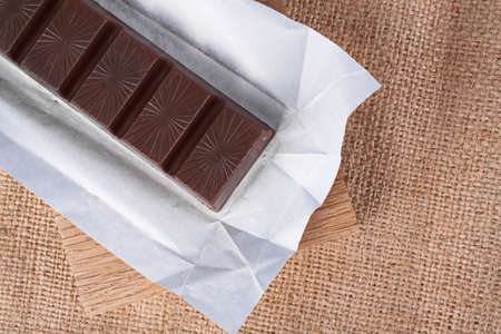 Chocolate bar on a white paperの写真素材