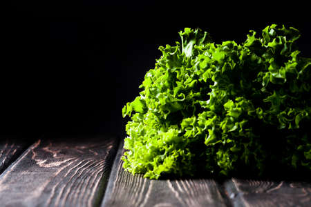 Salad leaf. Lettuce on wood boardの写真素材