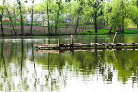 Old wooden pier on a lakeの写真素材
