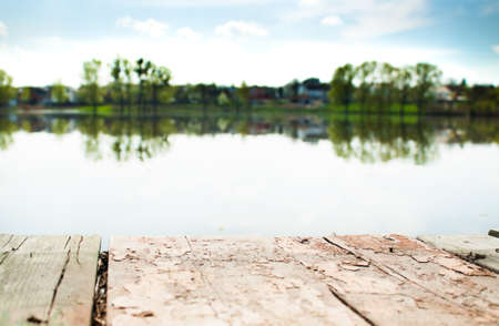 Old wooden pier on a lake at sunrise.
